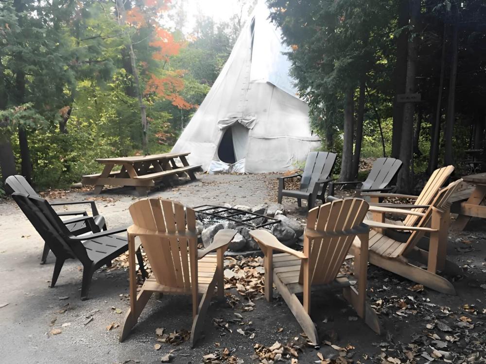Chair's around fire pit at site New Earth Estate