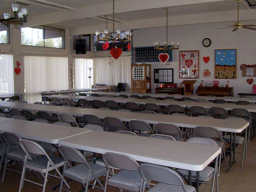 Table and chairs set up in the rec hall