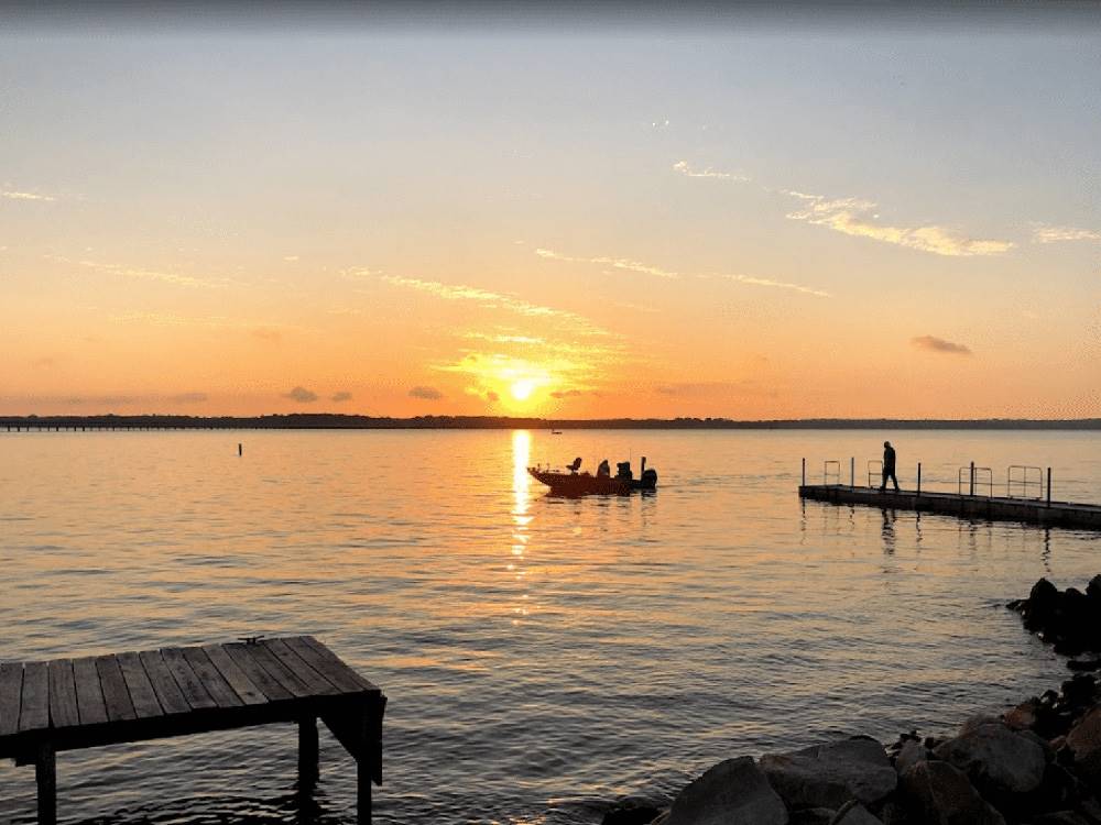 Fishermen in a boat at sunset