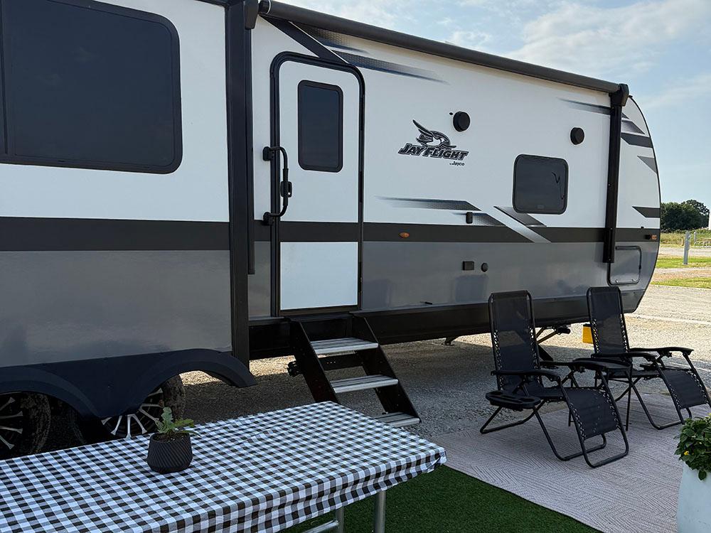 A large RV and a picnic table at site