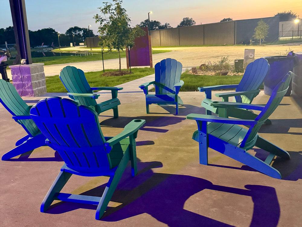 Adirondack chairs under a covered seating area