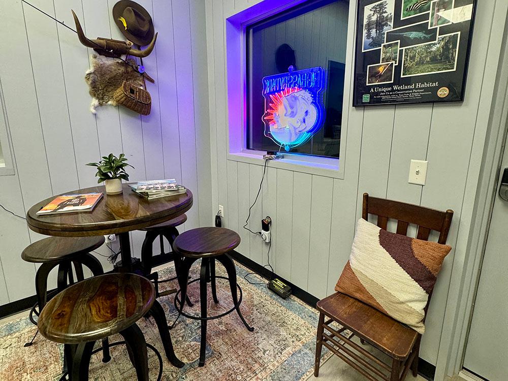 A tall table and three stools in the rec room