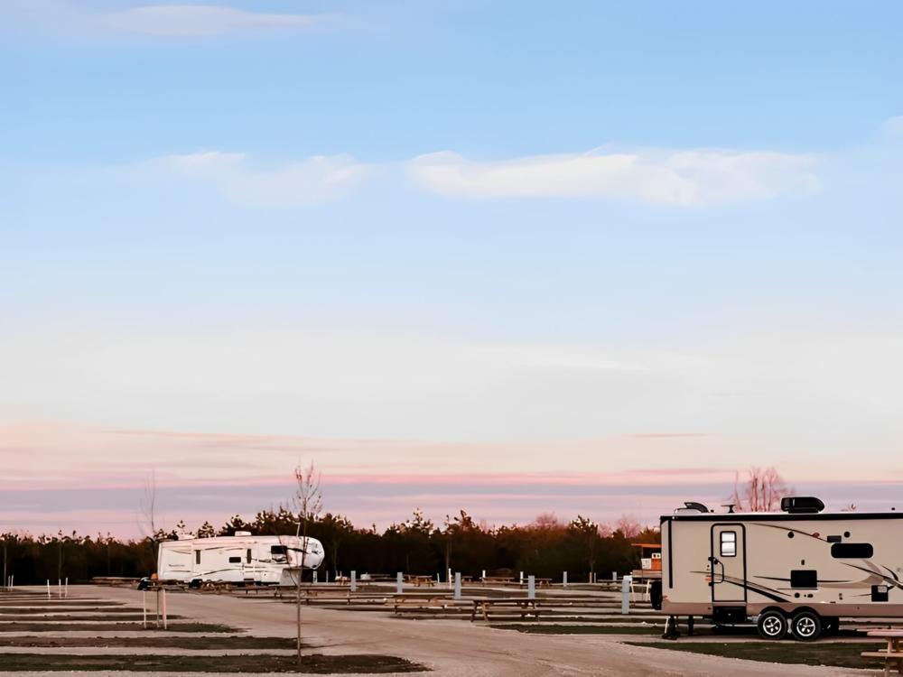 Parked RV's with open RV spaces at site Blue Lakes Adventure Camp