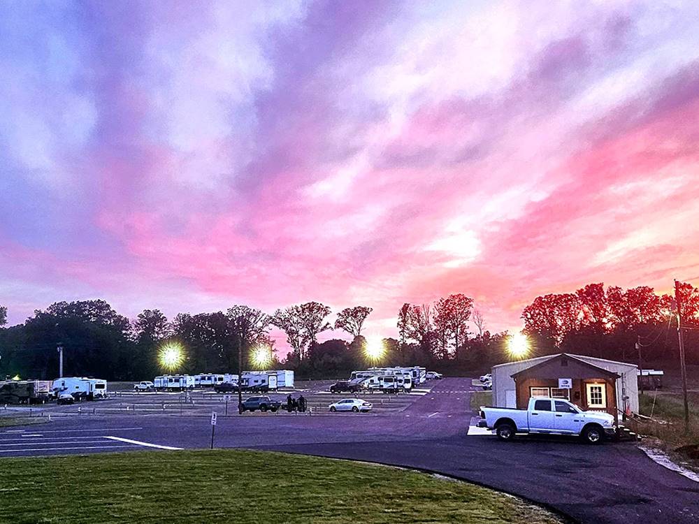 A multi colored sunset over the park