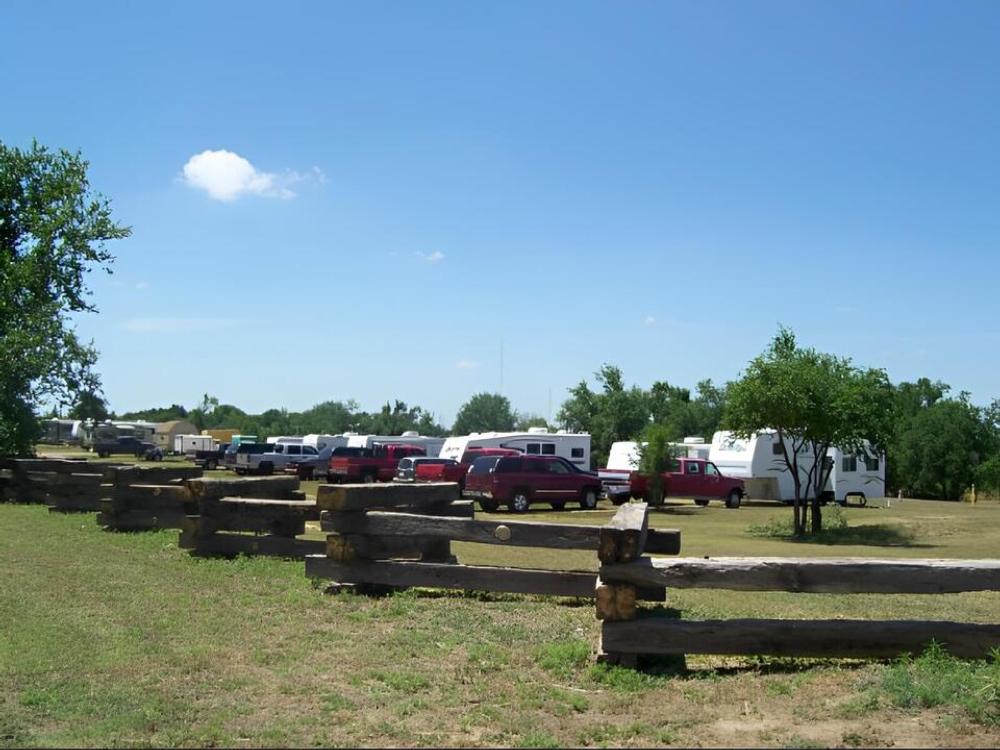 RV sites by a railroad tie fence at Red Deer Villa RV Ranch