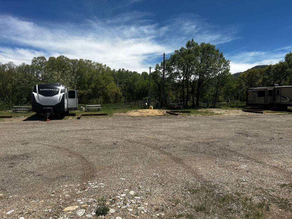 Trees and picnic tables near sites