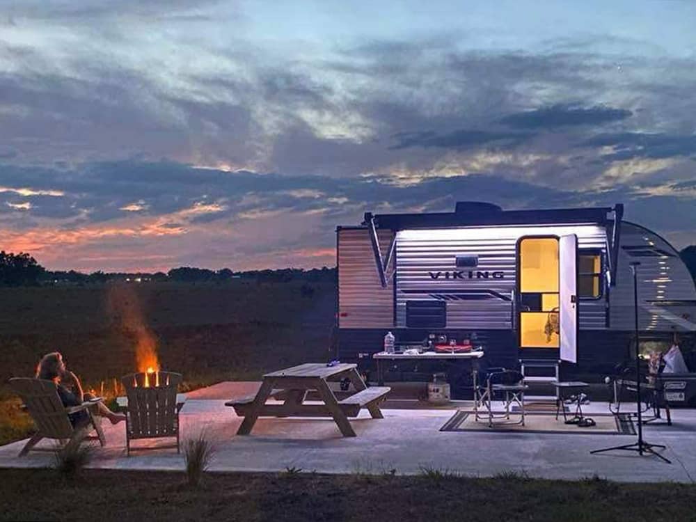 A paved RV site at night
