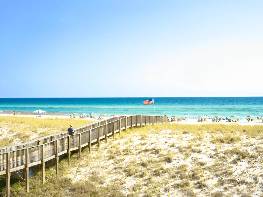 A man walking toward the ocean at Island Time RV Resort