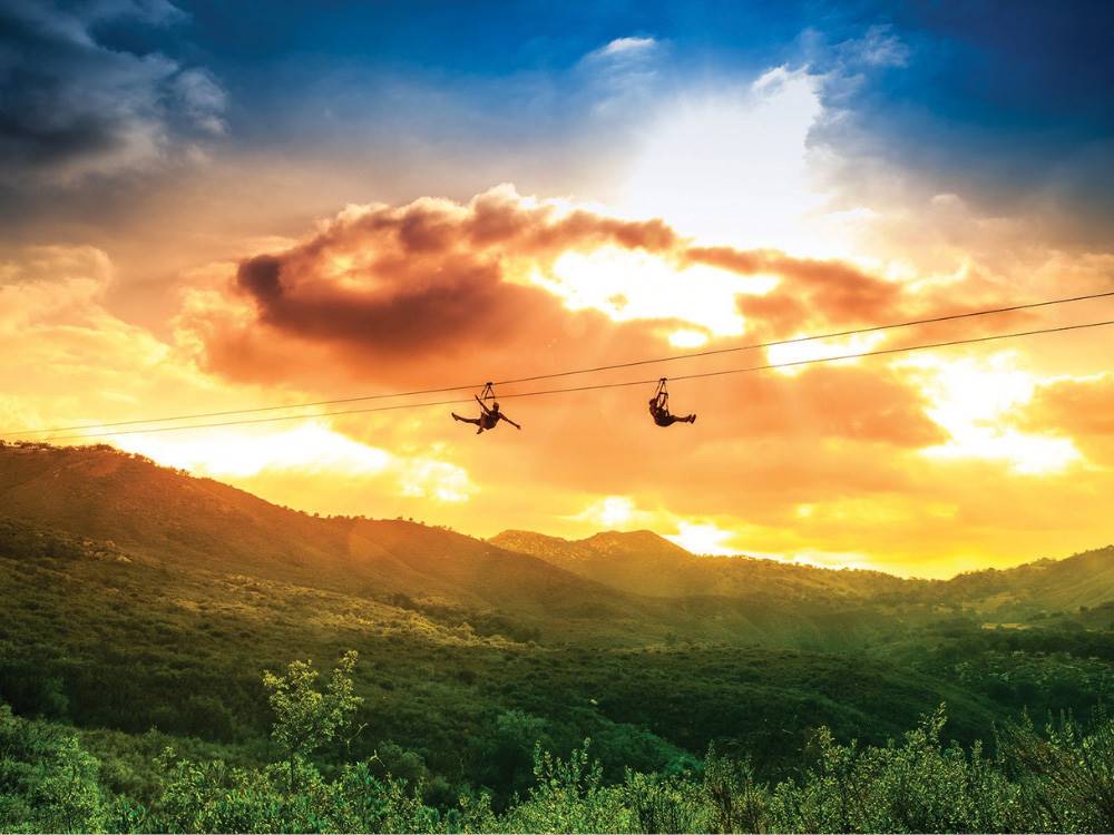 Zipliners at sunset