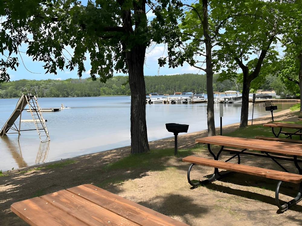 Picnic tables by the lake at Golden Acres Park