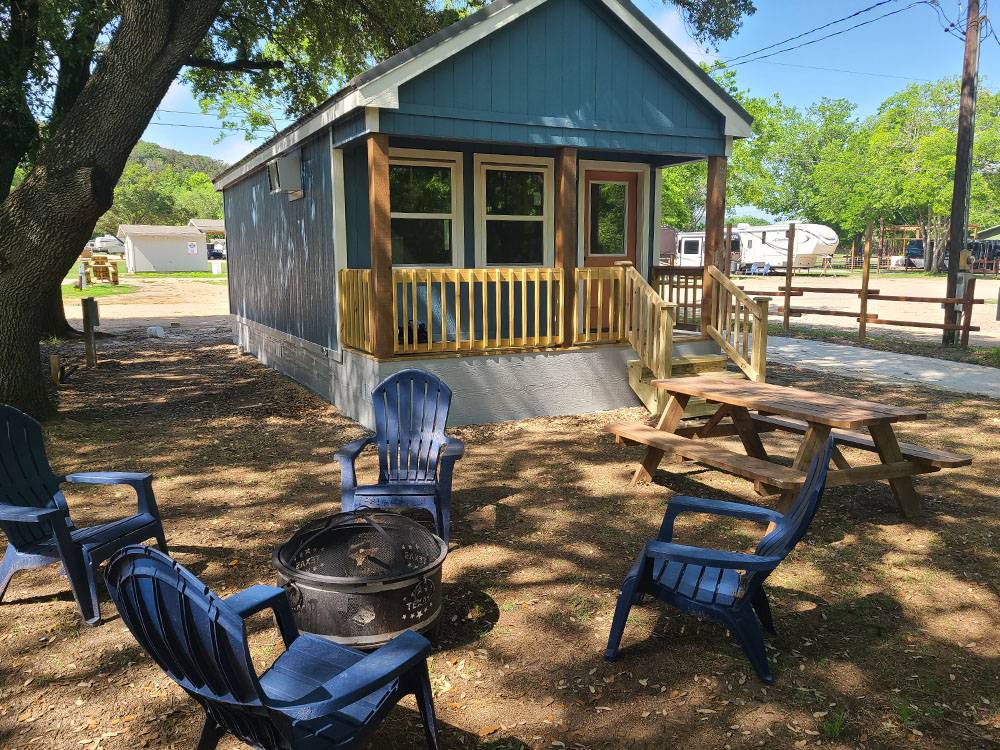 A rental cabin and seats around a fire ring