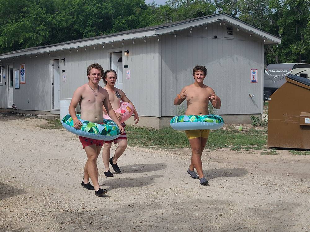 Teenage boys wearing ring floaties
