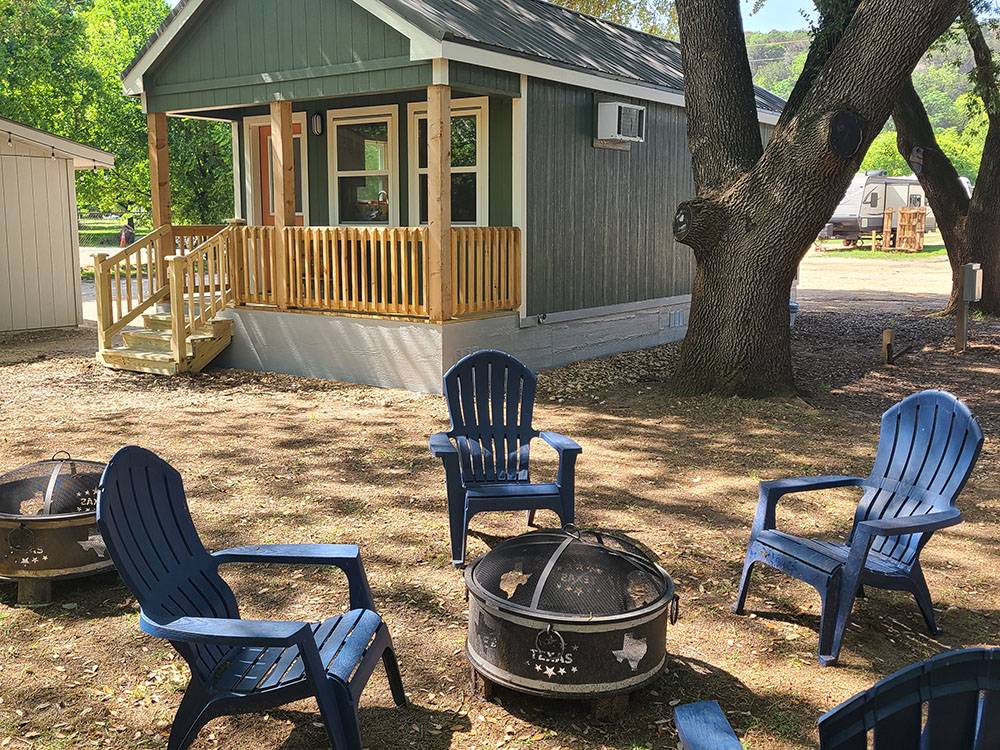 A cabin, Adirondack chairs and fire ring