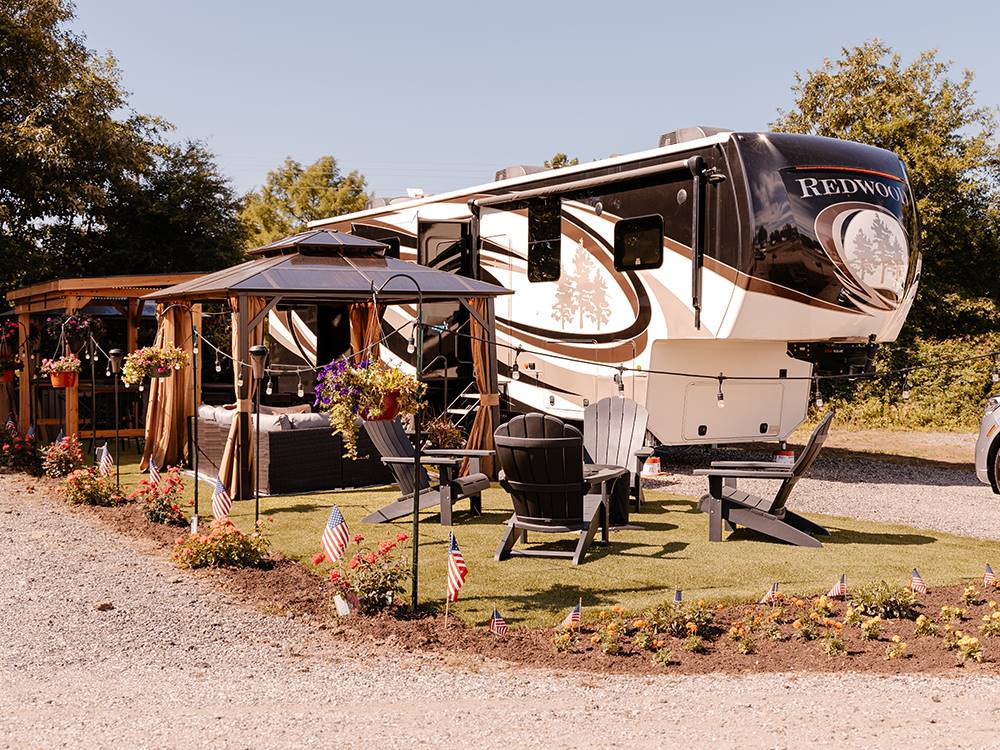 A RV site with fire pit and pergola