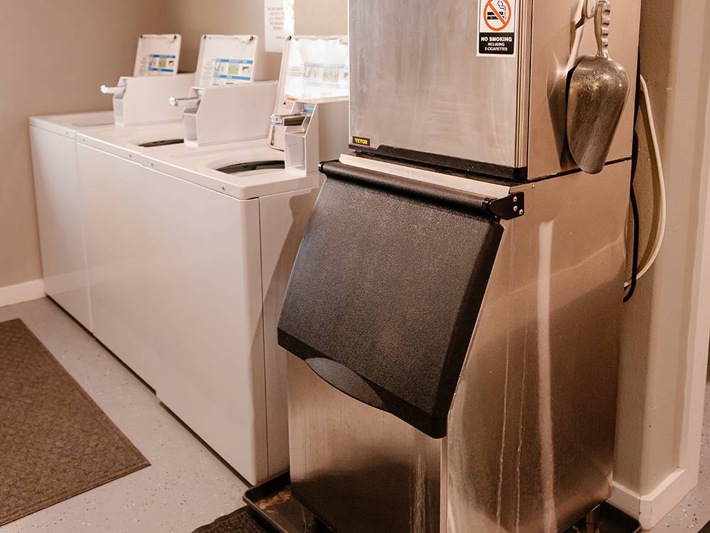 An ice machine and washers in the laundry room