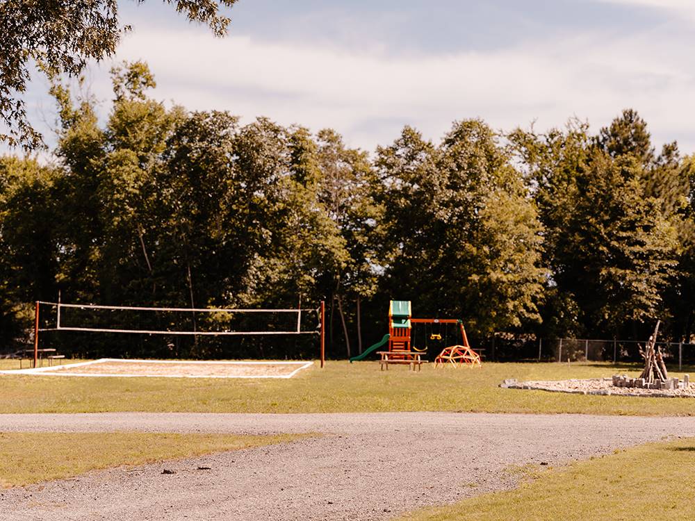 The volley ball net, playground and fire pit