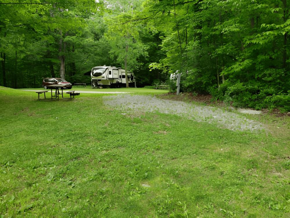 Parked trailer at site Stetson's Tumble Hill Campground