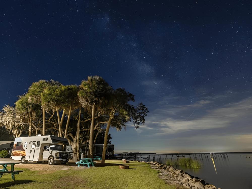 Parked RV with water view at Pine Island RV and Marina