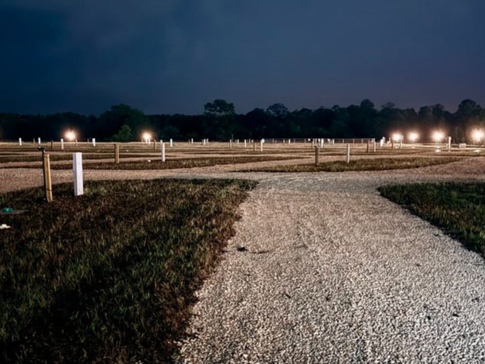 Gravel RV sites at night at Sharrah's RV Park