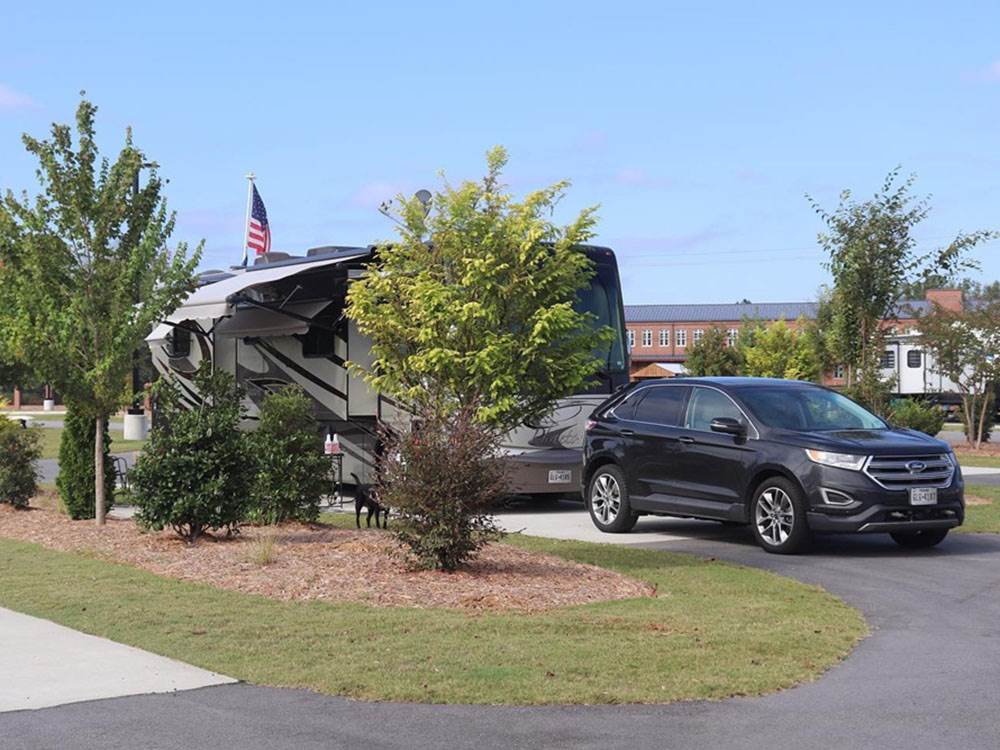 An RV and tow vehicle at a site