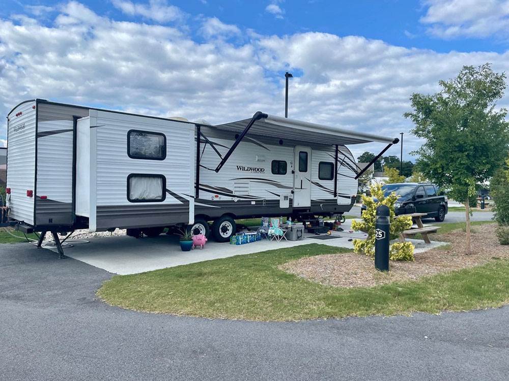 A travel trailer with an awning and a slide-out