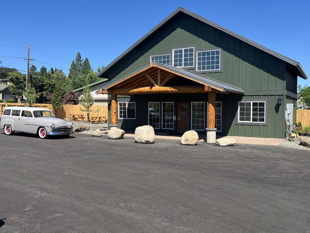 A vintage car parked in front of the office