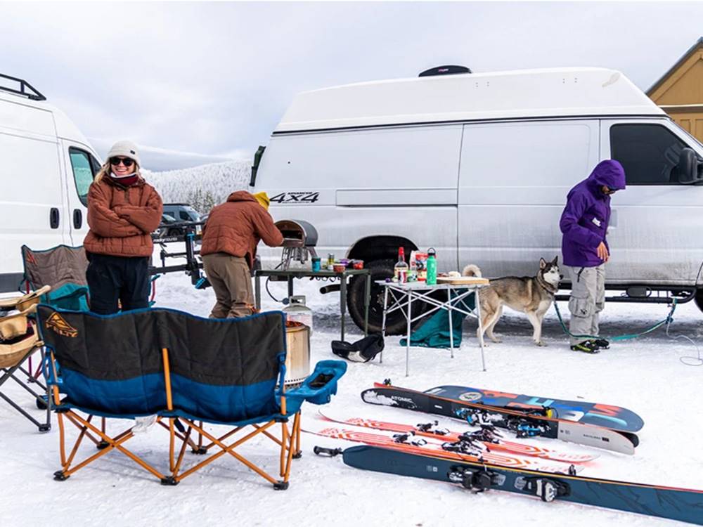 Parked RVs in winter with people and dog