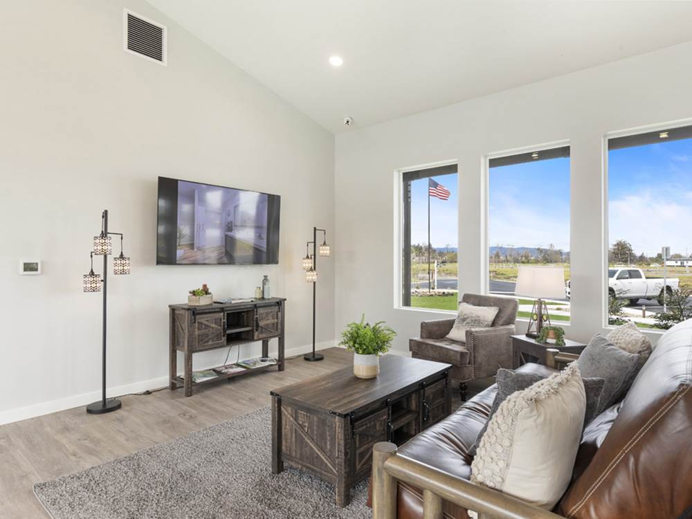 Couches, chairs and big screen TV seating area