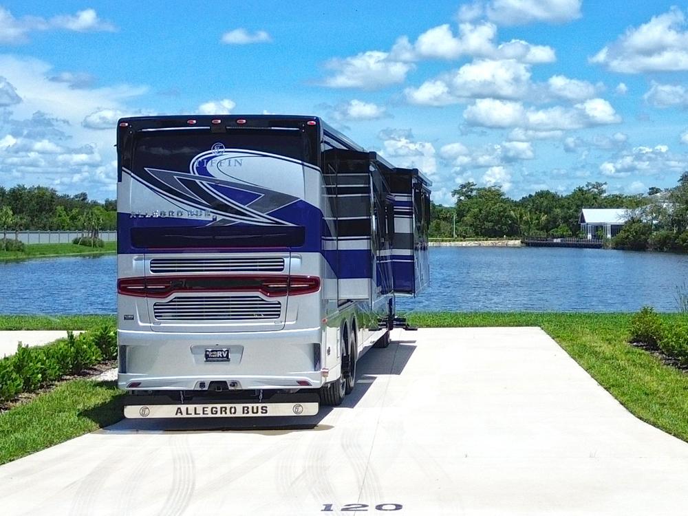 A motorhome in a paved site by the lake