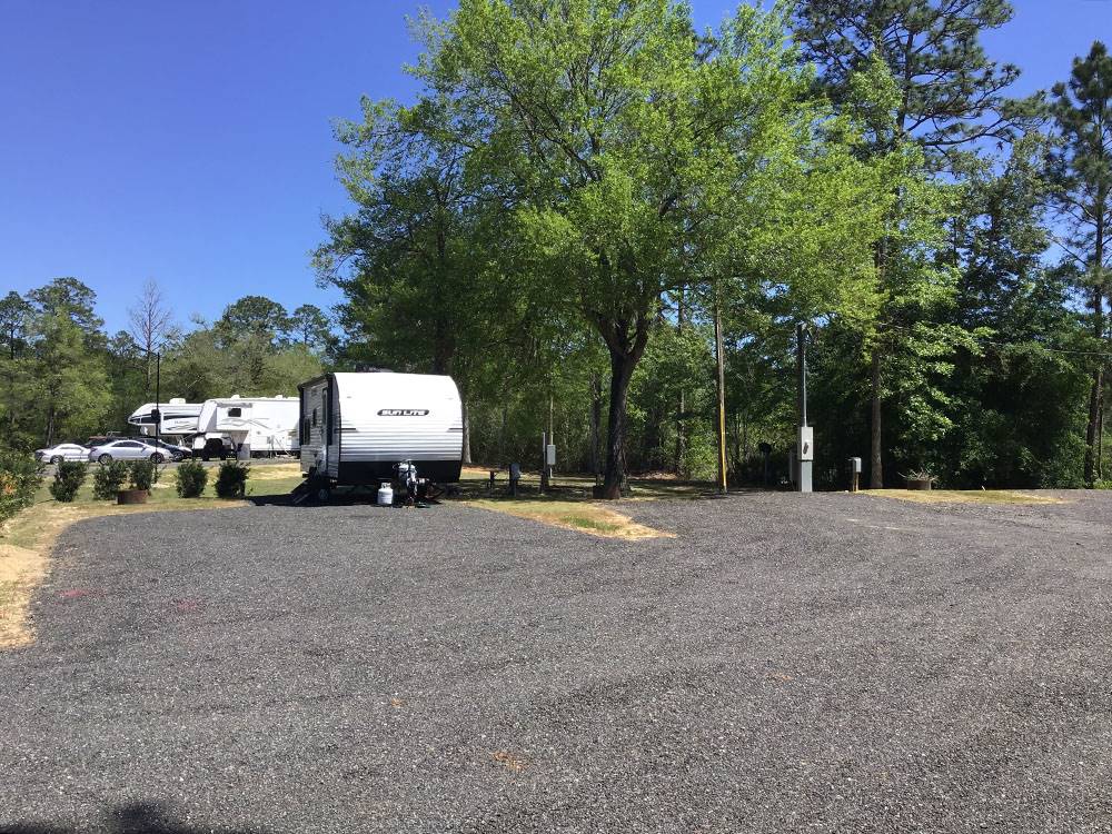 A travel trailer parked in a gravel site