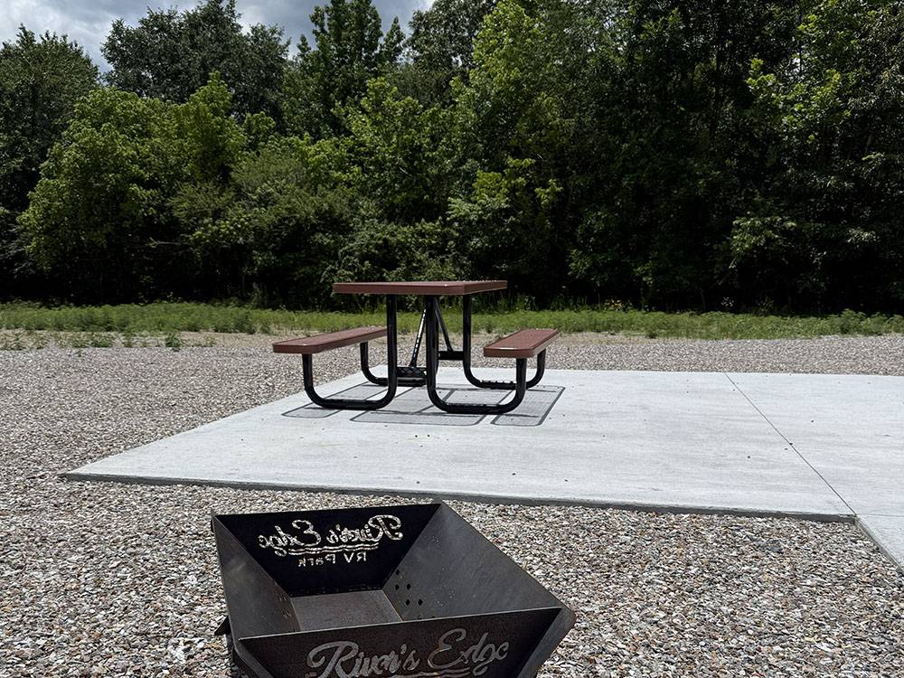 Paved site with a table and a fire pit