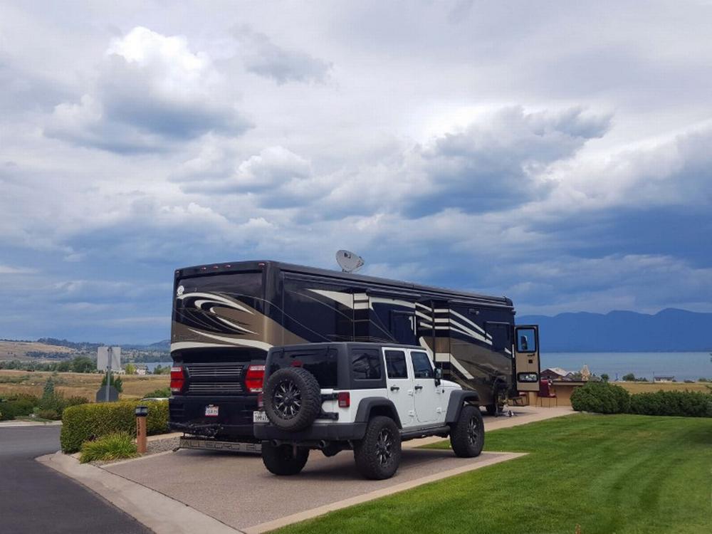 RV parked near jeep at site Roaming Trails RV Retreat Burleson