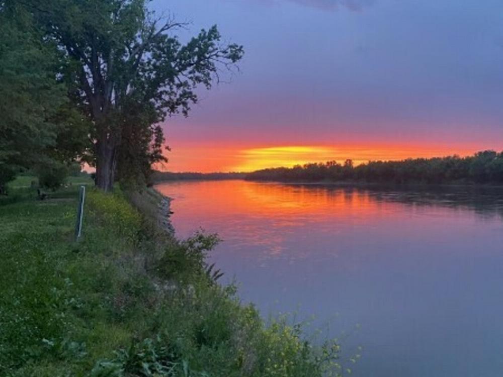 Sun setting over lake at site Lennie's River Retreat