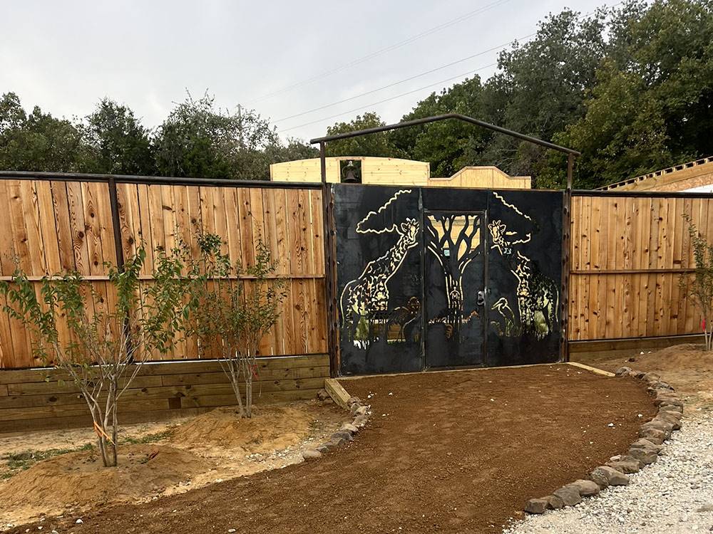 A dirt road leading to a gate
