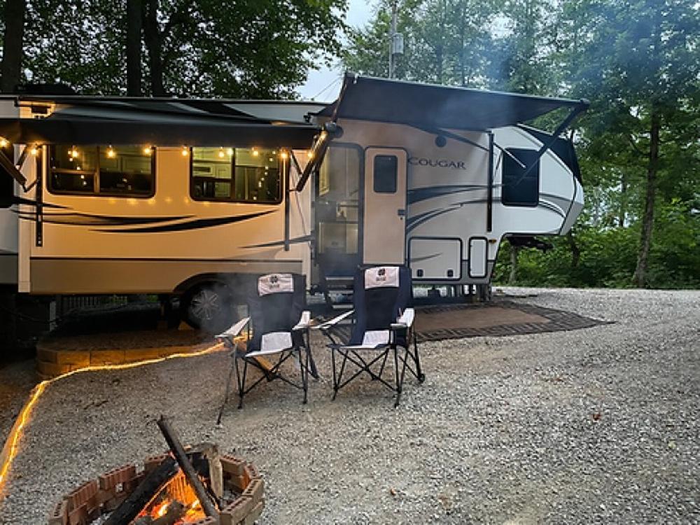 Parked trailer with fire pit at Camper Hollow RV Park and Campground