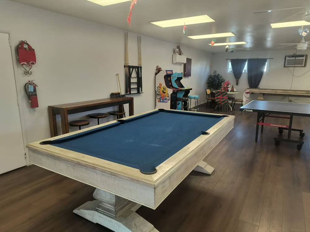A billiard table in the rec room