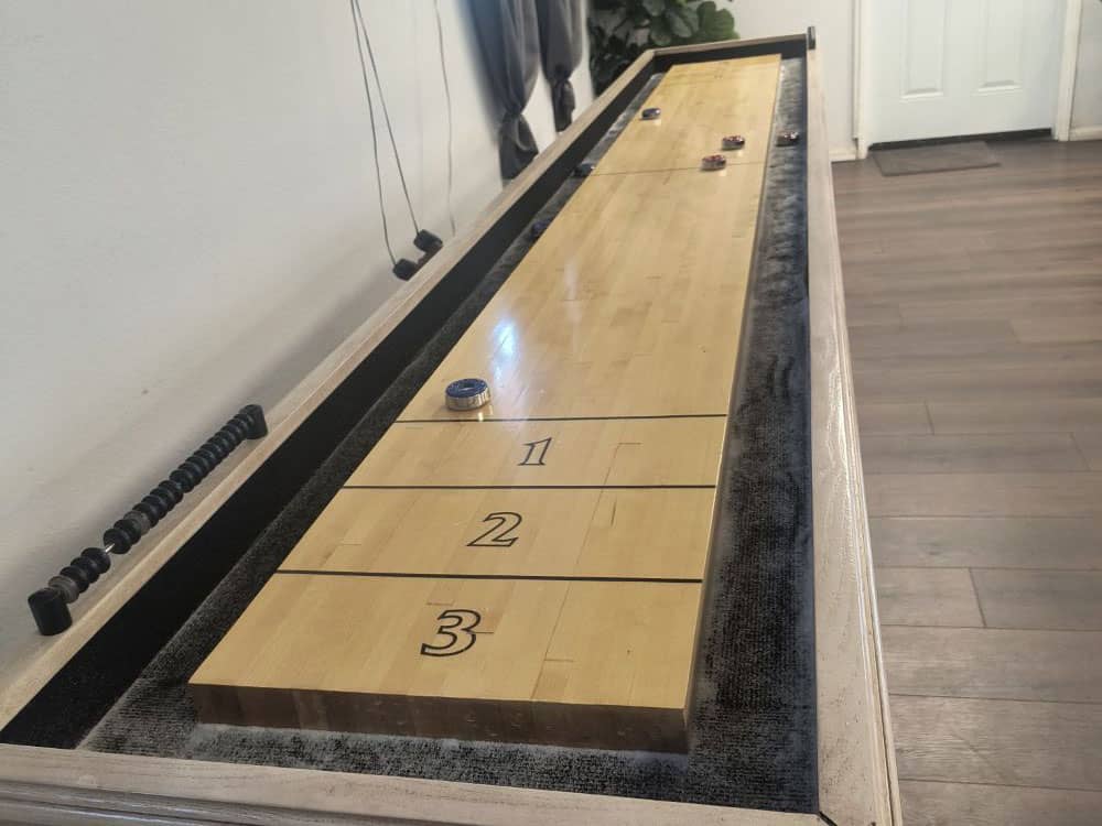 A shuffleboard table in the rec room