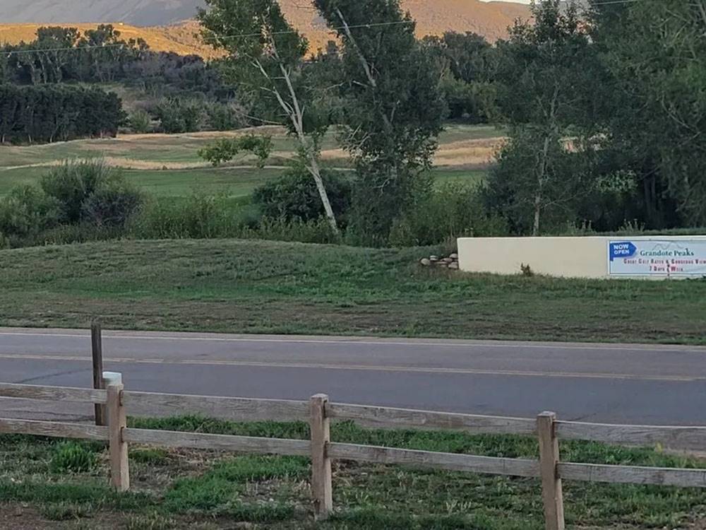 A view of the mountains beyond a rustic fence