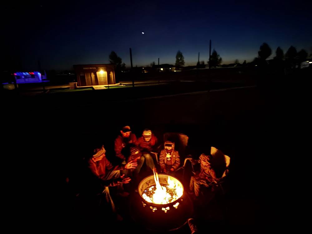 People gathered around a fire pit