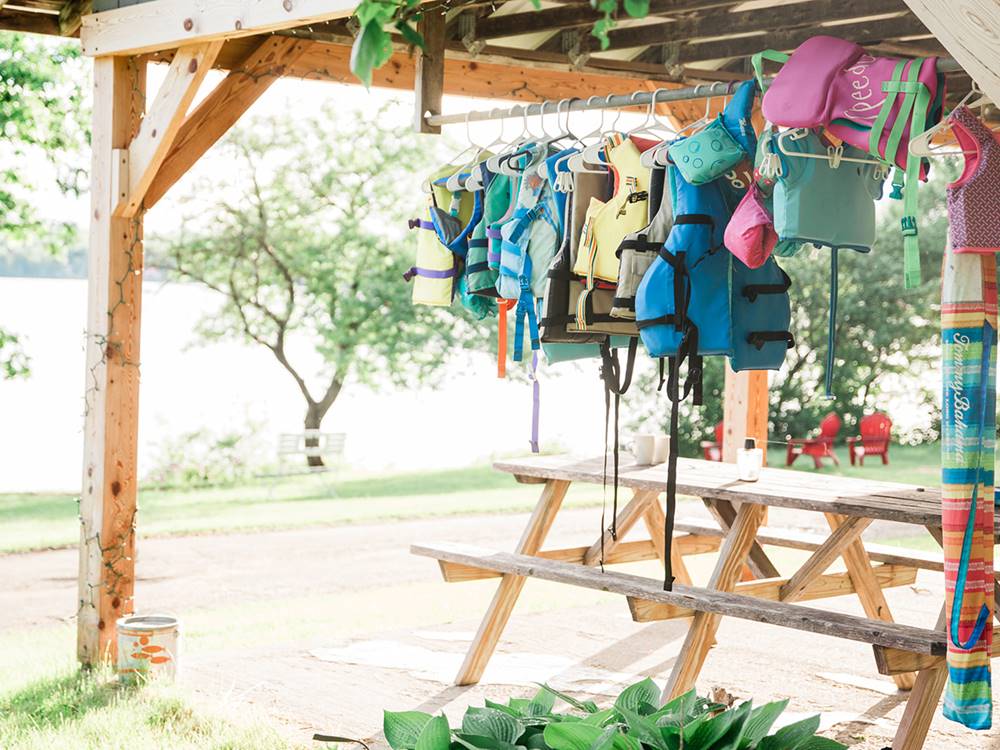 A covered picnic table and hanging life vests