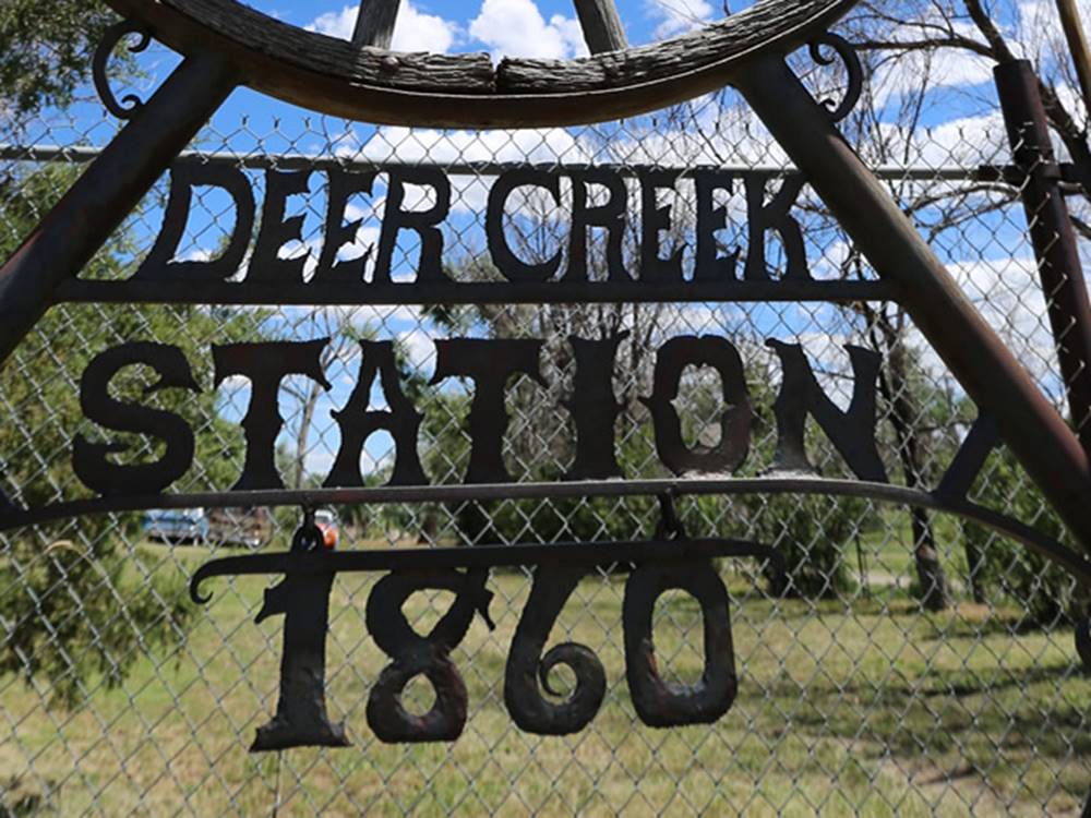 A rustic metal park sign
