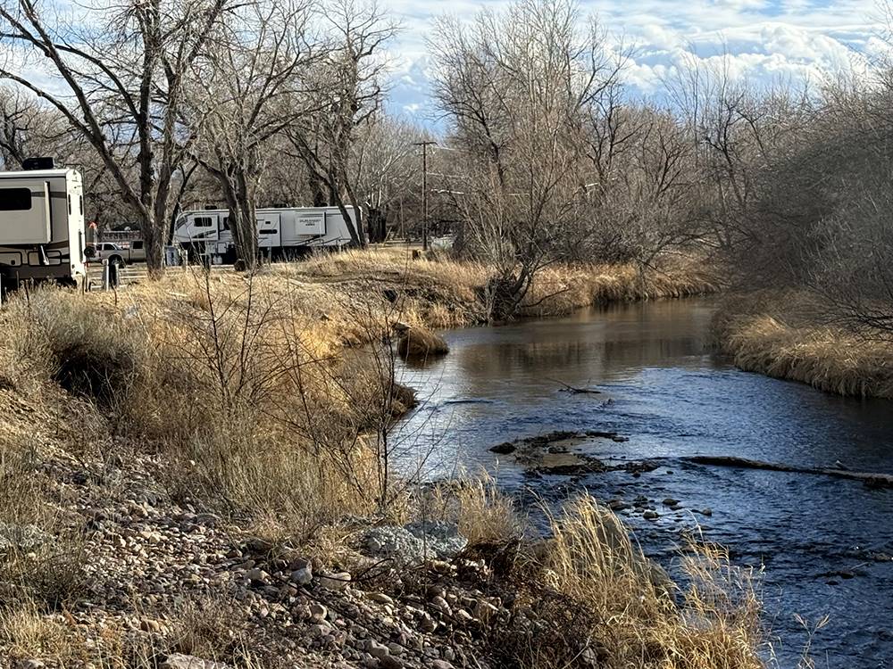 RVs parked alongside a stream