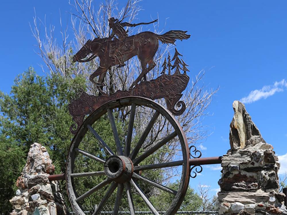A metal sculpture on a wagon wheel