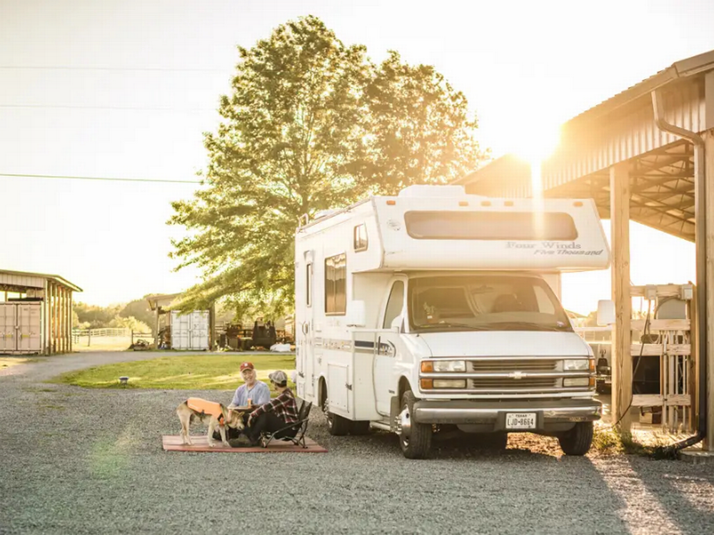 Couple sitting next to their rv