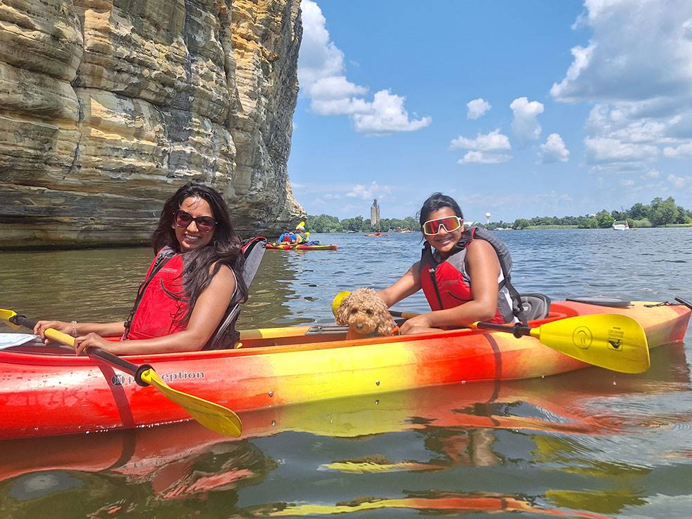 Two women and a dog in a kayak