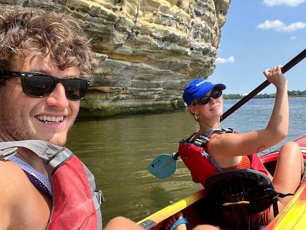 A man and woman taking a selfie in a kayak