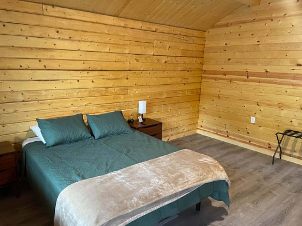 A queen bed in a rental cabin