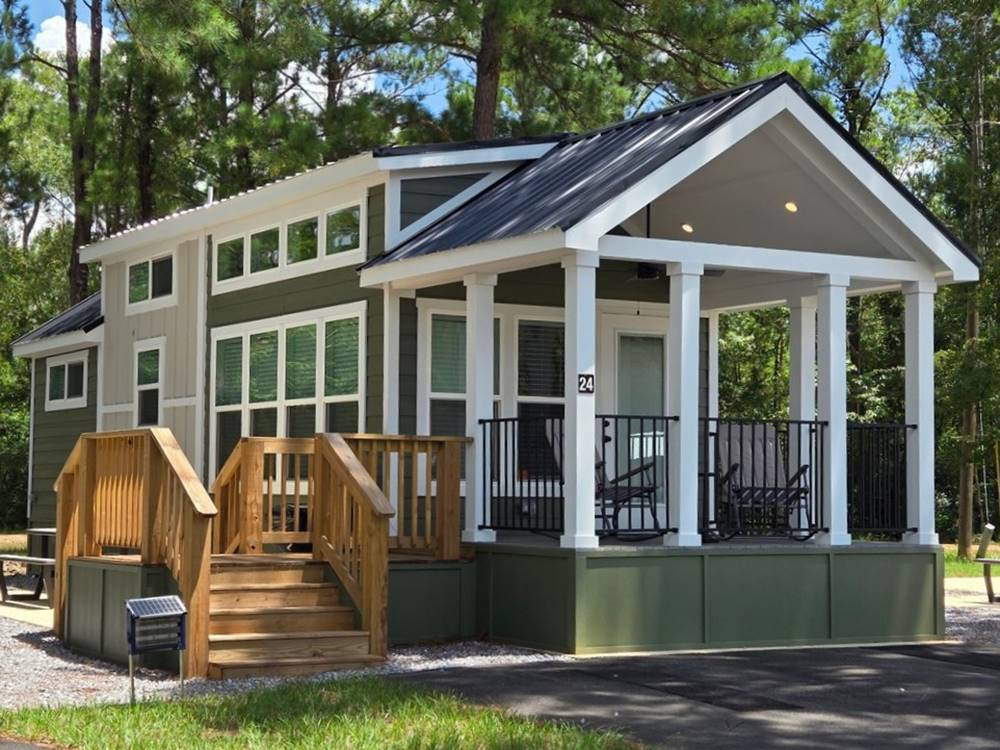 A tiny home cabin with a covered porch