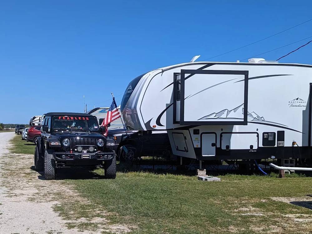A fifth wheel parked at a site