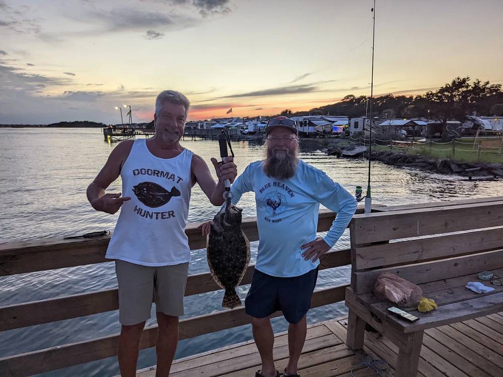 Men holding a fish they caught